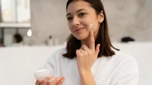 women Appling Moisturizer